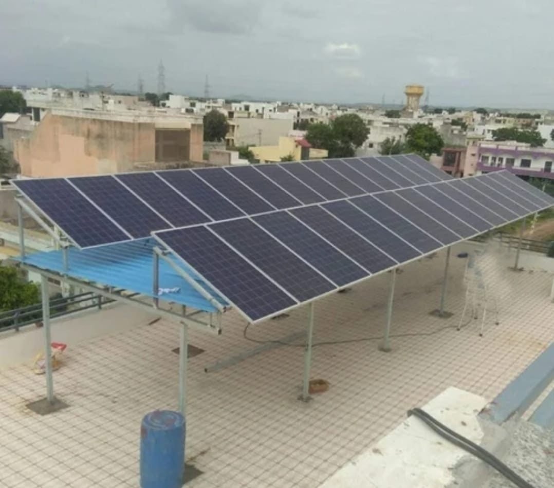 Solar panels on an elevated mounting structure on a Jaipur rooftop